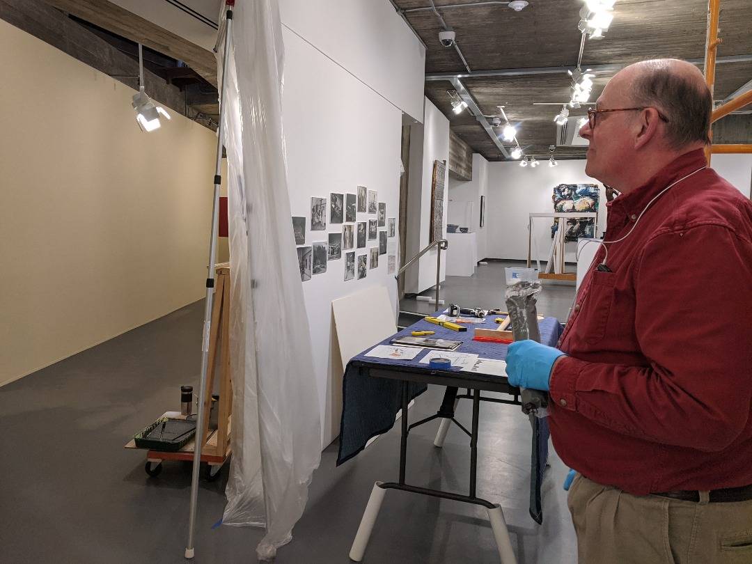 Scott Lewis in the gallery with tools