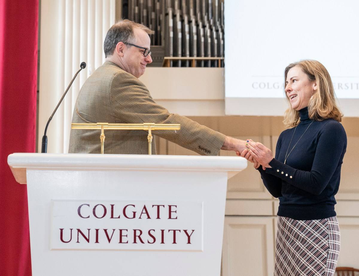 Kim Taylor receives the Employee of the Year Award from Christopher Wells